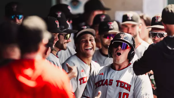 Logan Hughes celebrates his eighth inning home run in the Texas Tech dugout during Tech's 8-3 come-from-behind win at Baylor