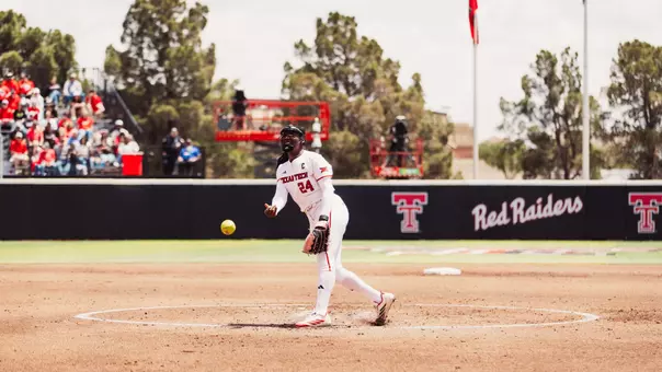 NiJaree Canady throwing a pitch against Baylor while wearing an all white uniform