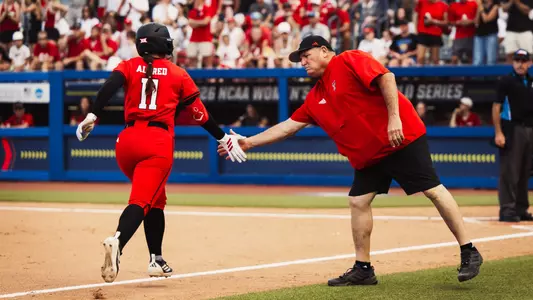 Lauren Allred jogs around the bases after hitting a solo home run against Alabama in the Women's College World Series.