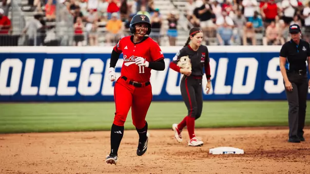 Lauren Allred jogs around the bases after hitting a solo home run against Alabama in the Women's College World Series.