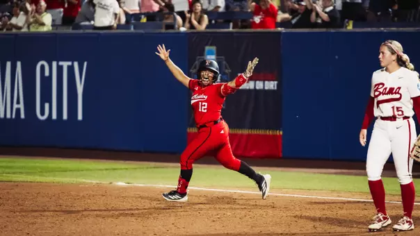 Jasmyn Burns celebrates while running the bases after hitting a home run against Alabama in the Women's College World Series.