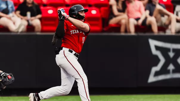 Logan Hughes swings a bat during a game at Rip Griffin Park
