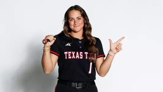 Bradi Gallaway posing with the 'guns up' symbol in a recruiting visist photoshoot