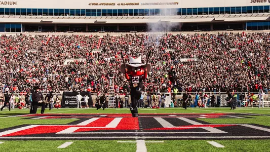 Raider Red shoots off his two shotguns at midfield prior to Texas Tech's 2025 home win over UCF.