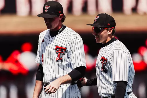 RHP Logan Bevis (left) and OF Logan Hughes walk off the field during a contest against Houston