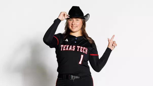 Hailey Maestretti doing the guns up pose at a photoshoot on a recruiting visit