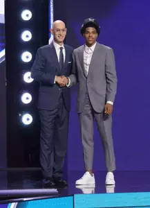 Christian Anderson and Adam Silver take a photo together on the NBA Draft stage after his selection.