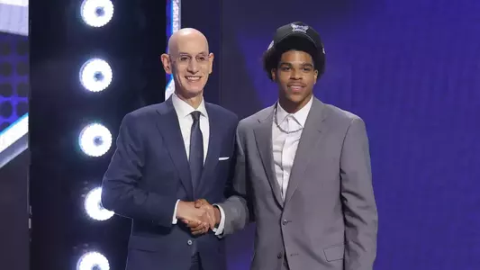 Christian Anderson poses with Adam Silver after being selected in the NBA Draft.