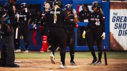 Mia Williams touches home plate after hitting a home run against Texas in the Women's College World Series.