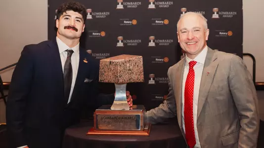 Jacob Rodriguez and Joey McGuire pose around the Lombardi Award after Rodriguez was named the 2025 winner of the prestigious trophy.