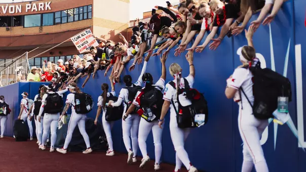 Texas Tech softball players are greeted by fans at the Women's College World Series.