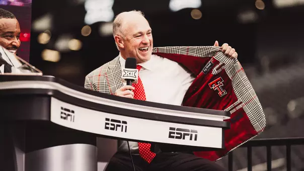 Joey McGuire shows off the Double T on the inside of his jacket during an interview on the ESPN set at Big 12 Media Days.