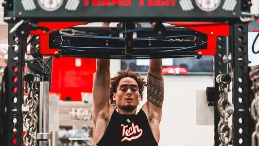 Dra Gibbs-Lawhorn does pullups in the Texas Tech basketball weight room during a summer workout.