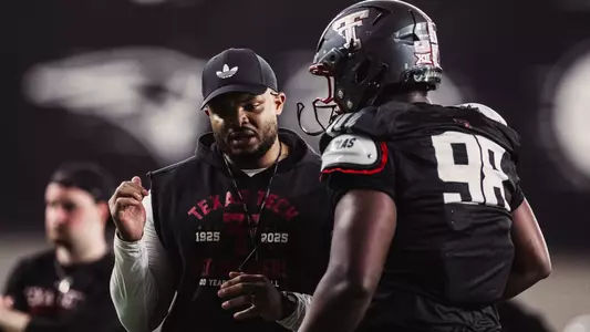 Imarjaye Albury Sr. working with a defensive lineman during fall camp