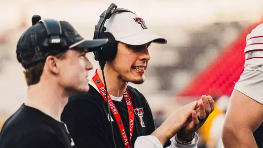 Josh Cochran clapping his hands as he coaches on the sideline of a Texas Tech spring game