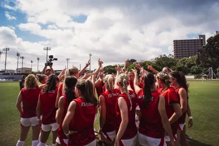 The Red Raiders huddle up with their guns up prior to the game against Hawaii