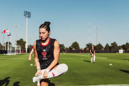 Emma Torres stretches prior to the Red Raiders contest against New Mexico