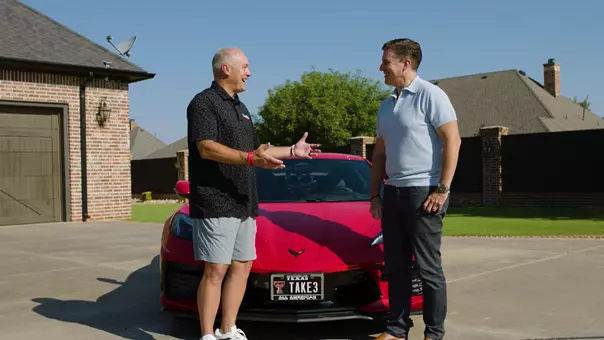 Joey McGuire and Rece Davis talk in front of McGuire's corvette as part of ESPN's Official Visit show.