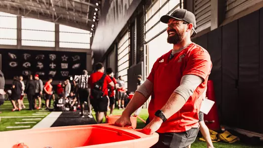 Dillon Barron pulling a hydration cart at football practice