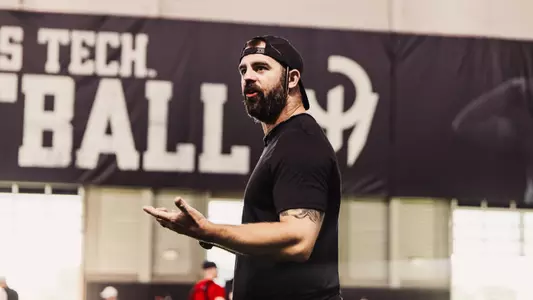 Aaron Hall giving instructions during football practice