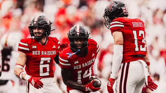 Brice Pollock celebrates alongside John Curry and Ben Roberts following an interception in one of Texas Tech's 2025 victories.