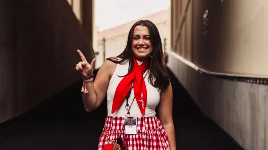 Katie Meade holding a Guns Up sign at the Galaxy Stadium tunnel