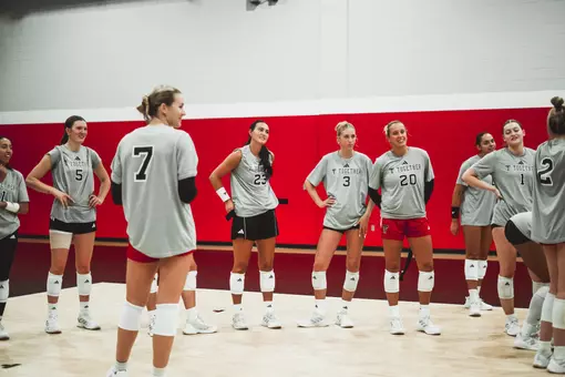 Team gathered around to listen to coach talk