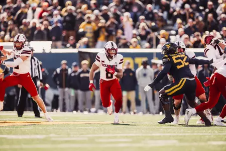 Dickey finding open field to run the ball towards the endzone.