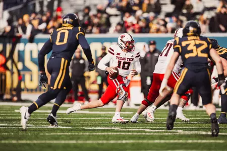 Jones making a big stride to run the ball downfield.