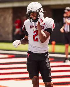 Johnson smiles after his team scores a touchdown during a scrimmage.