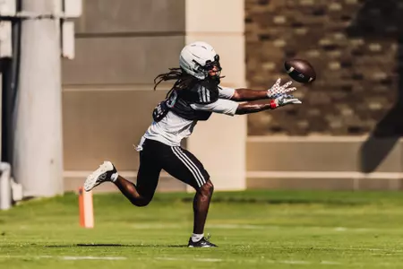 Cam Wyatt reaches out to catch a ball during a practice.