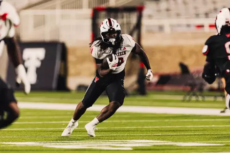 Ashton Rowden running the ball to make a play.