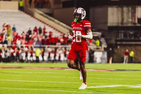 Braylan McDonald jogs down the field to warm up following a rain delay against Arkansas-Pine Bluff.