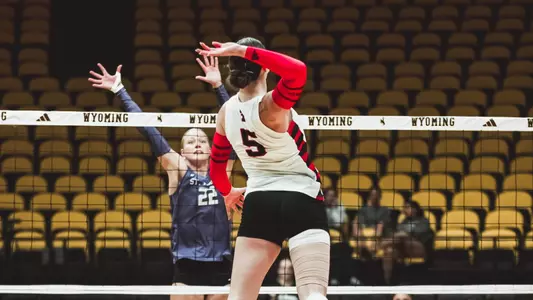 Elia Dinsmore taking a swing in a volleyball match against St. Thomas