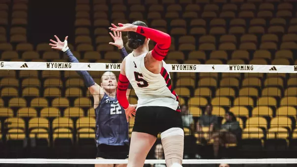 Elia Dinsmore taking a swing in a volleyball match against St. Thomas