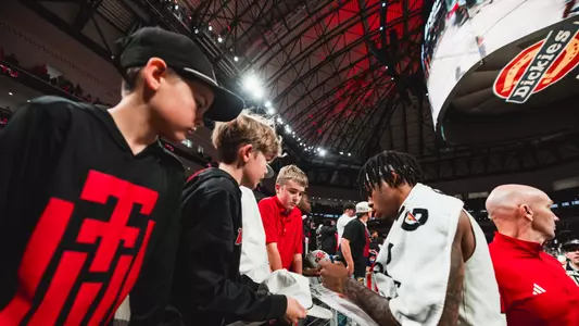 JT Toppin signs autographs for fans after a win over LSU at Dickies Arena.