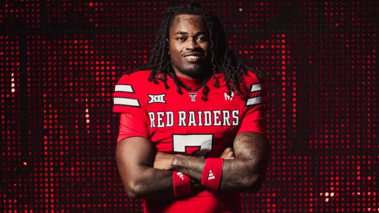 Terrance Carter Jr. poses in front of a red screen as part of Texas Tech's 2026 preseason content.