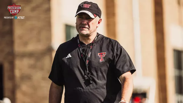Joey McGuire walks across the field early in one of Texas Tech's 2026 preseason practices.
