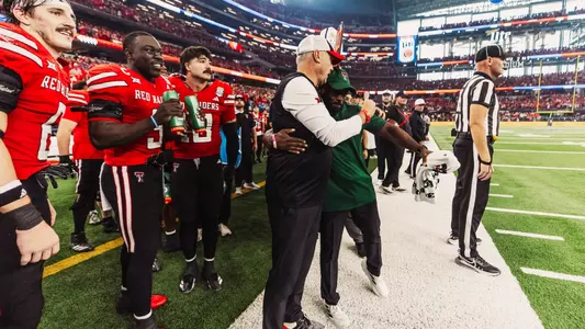 Quintin Jordan and Joey McGuire hug during the final moments of Texas Tech's win in the 2025 Big 12 Championship.