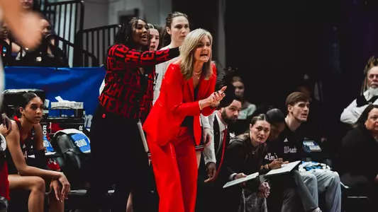 Gerlich standts sideline at the NCAA Tournament clapping
