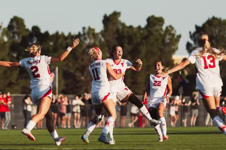 Kaitlyn Giametta (33) and the Red Raiders celebrate one of her two goals on Senior Night