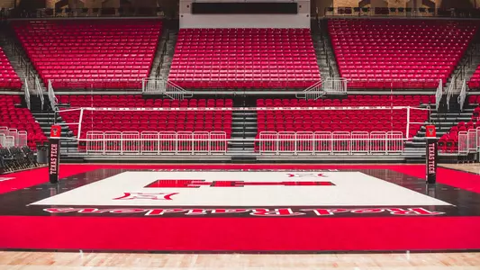 An image of an empty United Supermarkets Arena, featuring the new court surface used by the Red Raider volleyball program.