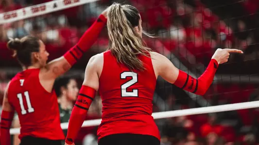 Gretchen Sigman pointing the ball in after scoring a point in a Texas Tech volleyball match