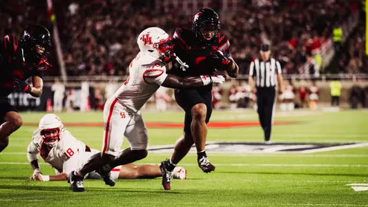 Cameron Dickey attempts to run through a Houston tackler during Texas Tech's victory over the Cougars.