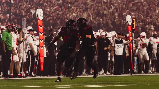 A.J. Holmes Jr. celebrates with Ben Roberts after recording a sack in Texas Tech's win over Houston.