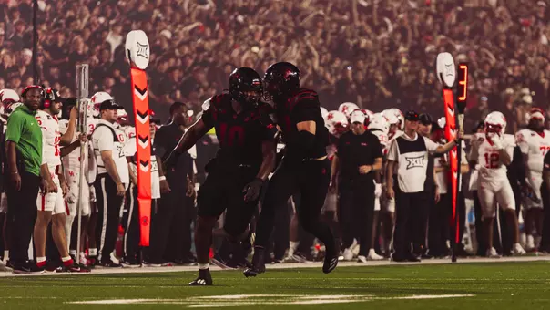 A.J. Holmes Jr. celebrates with Ben Roberts after recording a sack in Texas Tech's win over Houston.
