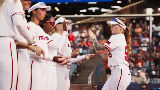 Kaitlyn Terry greeting her teammates as she runs out for the starting lineup