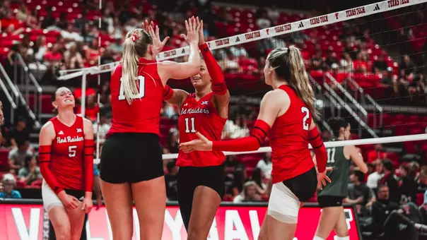 Tatum Johnson and Katelyn Cochran high fiving after a point for Texas Tech volleyball