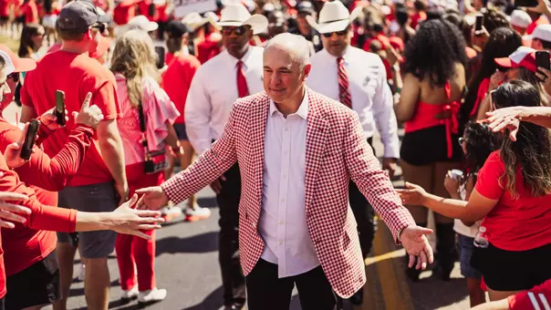 Joey McGuire greets fans while entering Galaxy Stadium during Texas Tech's Raider Walk tradition.