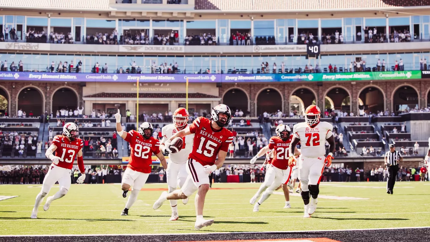 Austin Romaine celebrates after crossing the end zone following his second pick-six interception in Texas Tech's win over Sam Houston.
